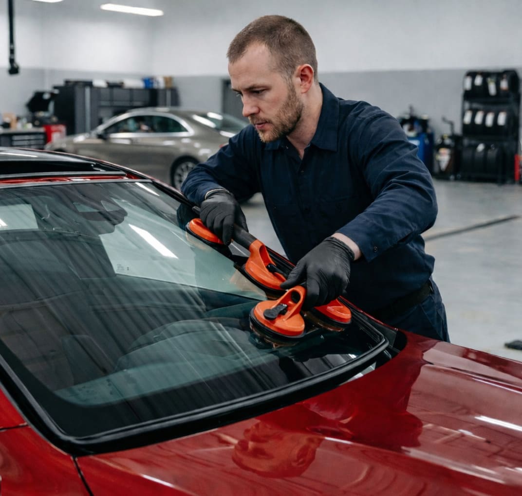 Technician installing windshield